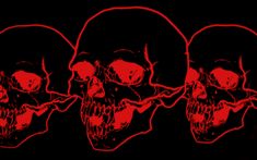 three red skulls are shown in the dark