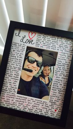 a photo frame with an image of a man and woman in sunglasses on top of it