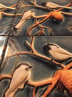 several birds are sitting on the branch of a tree in this artistic tile design that looks like it has been painted with acrylic paint