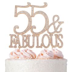 a 50th birthday cake topper that says 50 and fabulous