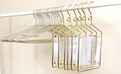 there is a rack that has some clothes hanging on it and one hanger attached to the wall