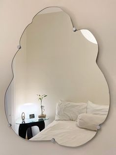 a mirror that is on the wall above a bed