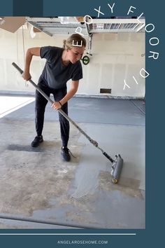 a woman with a mop is cleaning the floor in an empty garage or apartment