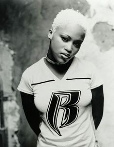 a black and white photo of a woman wearing a t - shirt with the letter b on it