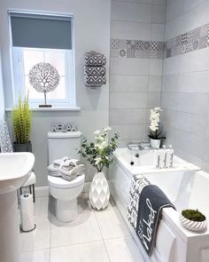 a white bathroom with gray and white decor