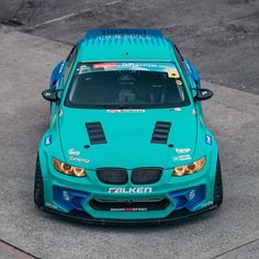 a blue car parked on top of a parking lot