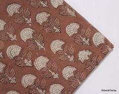 a brown and white fabric with leaves on it