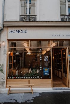 a store front with bottles on display in the window