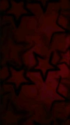 an abstract red background with black stars