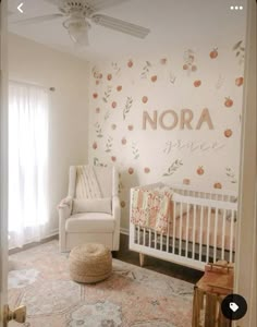 a baby's room with a white crib and floral wallpaper