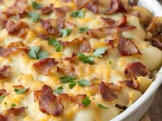 a casserole dish with bacon, cheese and parsley