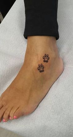 a person with a paw tattoo on their foot