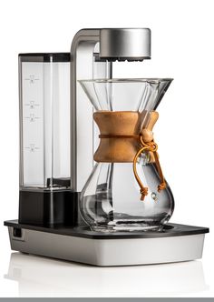 an espresso machine with a wooden handle and glass carafe on the top