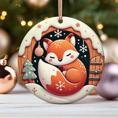 a christmas ornament with an image of a fox sleeping on it's back