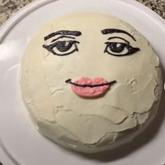 a white cake with a face drawn on it