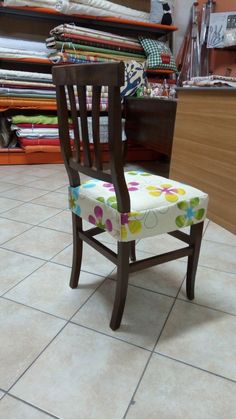 a wooden chair sitting on top of a tiled floor