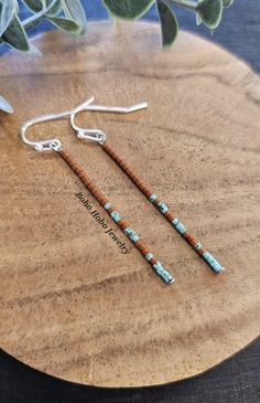 the earrings are made from wood and turquoise beads