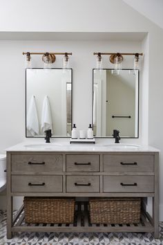 a bathroom vanity with two mirrors above it