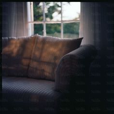 a couch sitting in front of a window