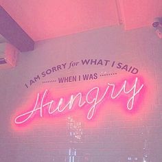 a neon sign that says i am sorry for what i said, when i was hungry