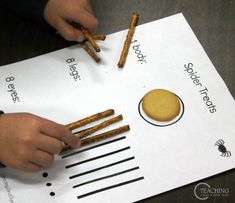 a child is doing something on top of a sheet of paper with sticks sticking out of it