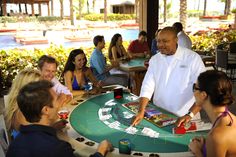 a group of people sitting around a casino table