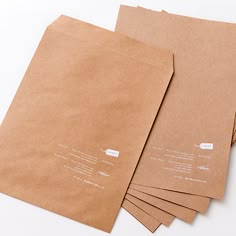 six brown envelopes are stacked on top of each other