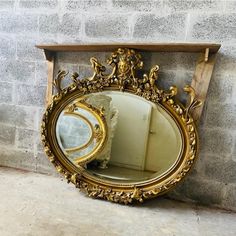 there is a mirror on the wall next to a shelf with a mirror in it