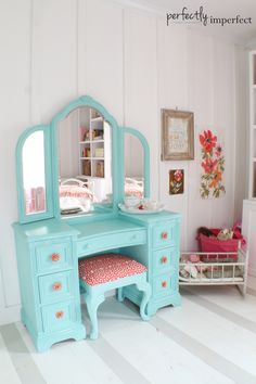 a doll house bedroom with a desk and mirror on the wall next to a bed