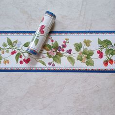 a roll of toilet paper sitting on top of a white floor next to a blue and red border