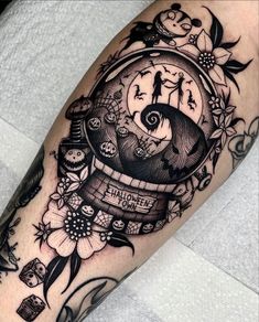 a black and white tattoo with an image of a clock on it's arm