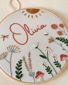 a embroidery project with the word julia written in cursive writing and flowers on it