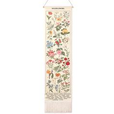 a white wall hanging with flowers on it