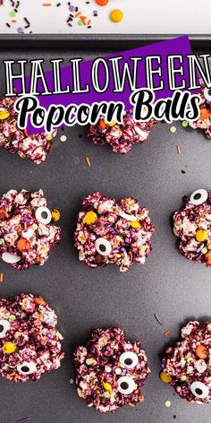 halloween popcorn balls with eyes and sprinkles on a baking sheet, surrounded by confetti