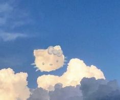 two hello kitty heads are floating in the clouds