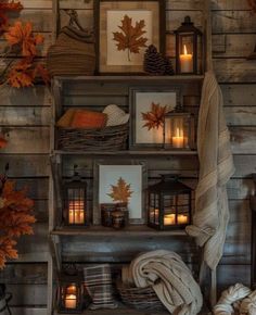 a shelf filled with candles and pictures on top of it next to other items in front of a wooden wall