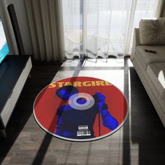 a living room with a large round rug on the floor