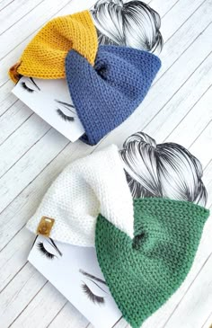 three knitted beanies on top of each other