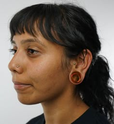 a close up of a person with ear piercings