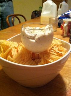 a white bowl filled with chips and dip