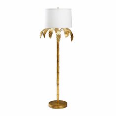 a gold palm tree lamp with a white shade on it's head and base