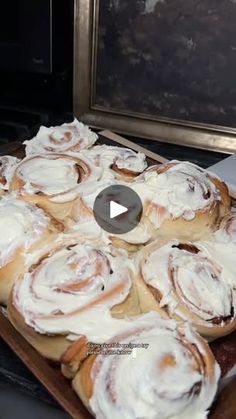 a tray filled with cinnamon rolls sitting on top of a counter next to a microwave