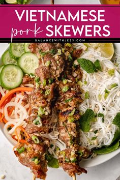 vietnamese pork skewers with noodles and vegetables on a plate