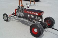 a man standing on top of a small engine powered car