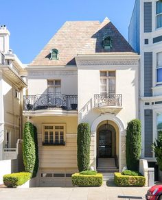 a large white house with many windows and balconies