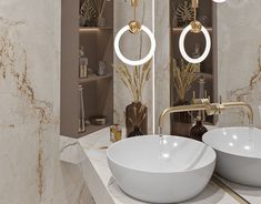 two white bowls sitting on top of a counter next to each other in a bathroom