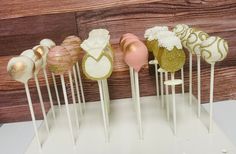 cake pops with gold and white frosting on top are lined up in a row