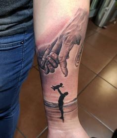 a woman with a tattoo on her arm holding the hand of another person's hand