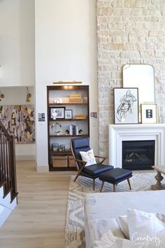 the living room is clean and ready for us to use it's fireplace as a focal point