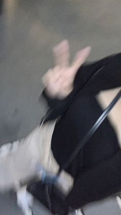 a blurry image of a woman sitting on the ground with her legs spread out